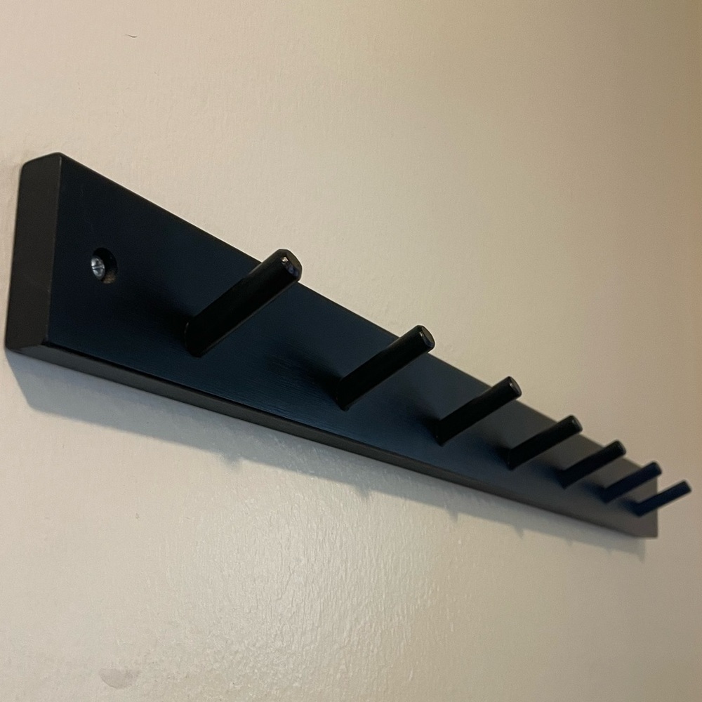 Black Coat Rack. 24” wide x 2” tall. Almost 3” between hooks.